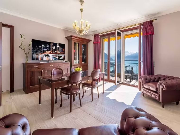 Spacious living room with panoramic Lake Geneva views, Chesterfield sofas