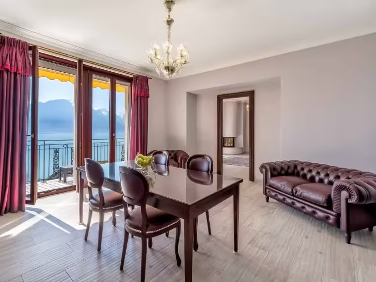 Living and dining area with lake and Alpine views