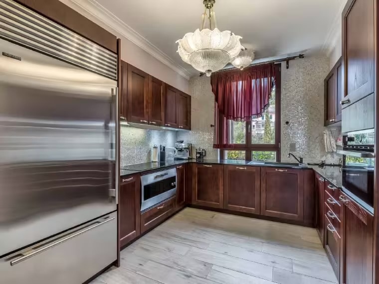 Fully equipped kitchen with dark wood cabinetry and Sub-Zero appliances