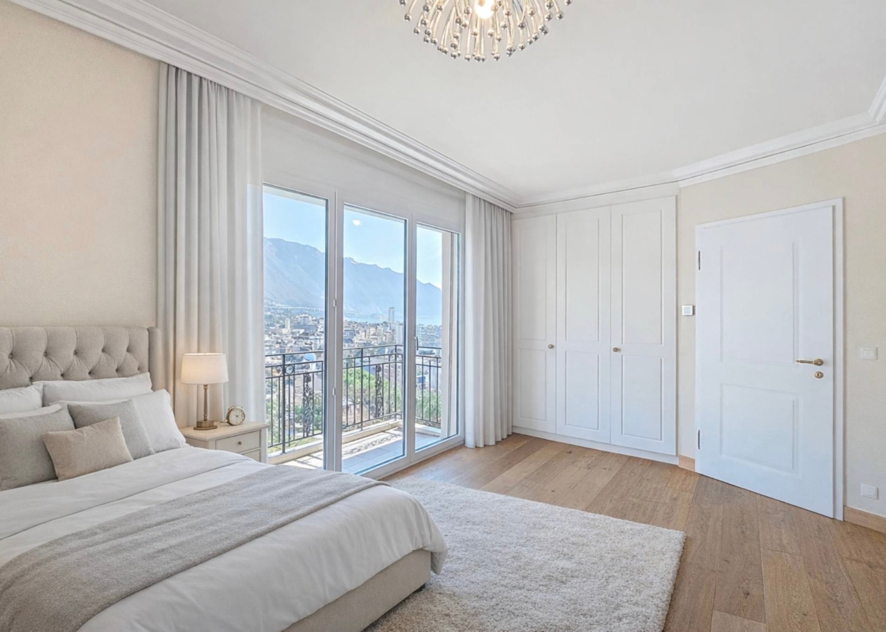 Master bedroom with chandelier and balcony access, Château Belmont penthouse Montreux