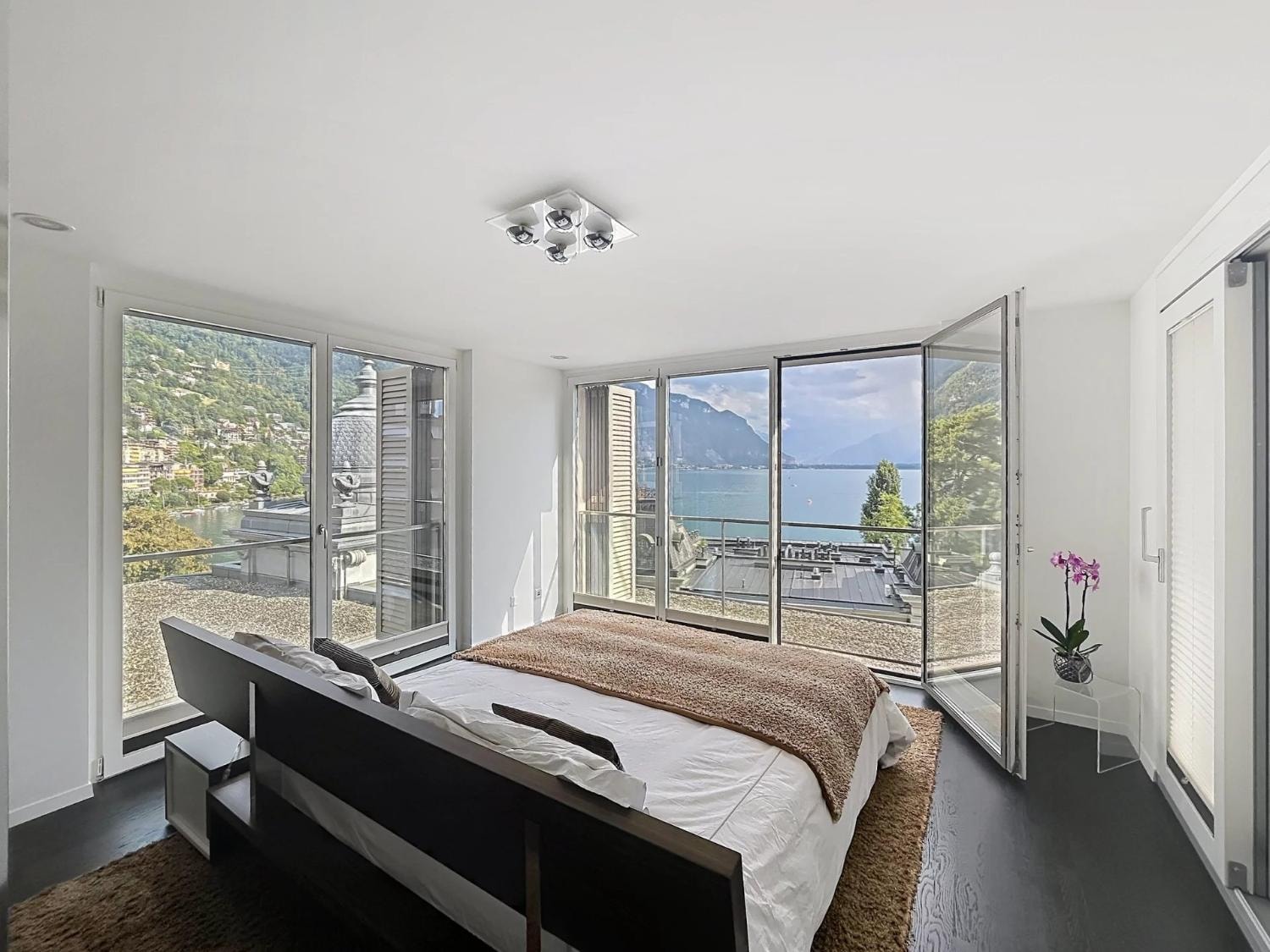 Master bedroom with floor-to-ceiling windows and Lake Geneva views, Le National, Montreux