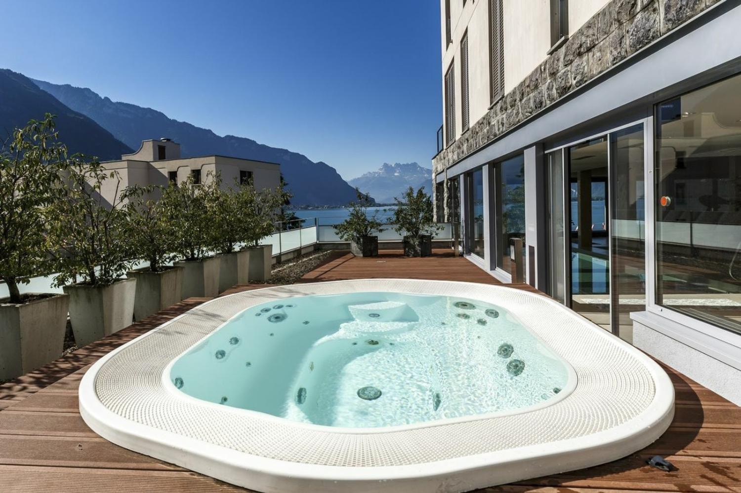 Outdoor jacuzzi terrace with Alpine lake views, Le National residence, Montreux