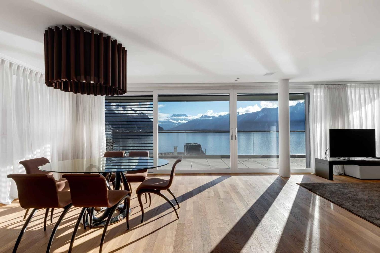 Elegant dining room lake mountain views Montreux luxury apartment